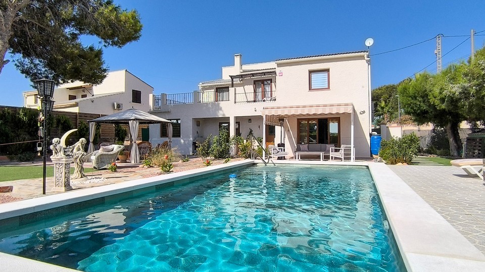Private swimming pool surrounded by mature gardens